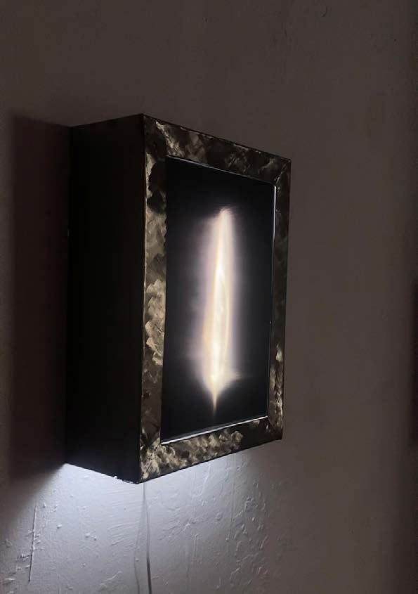 The lightbox seen at an angle, its edge catching the light.