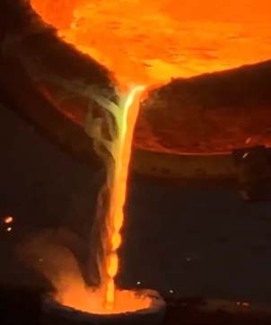 Molten bronze pouring into the mould.